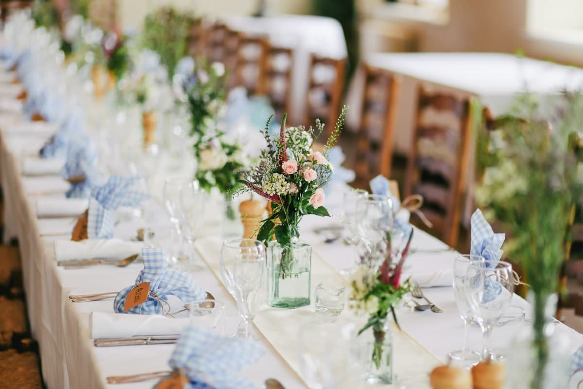 Refined banquet dining table with fresh floral centerpieces and glassware