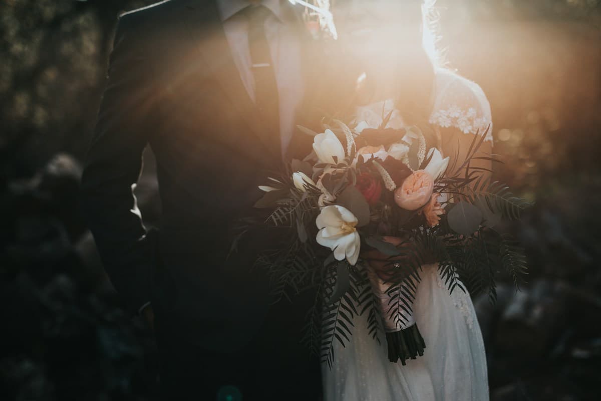 Golden hour wedding portrait with bespoke floral bouquet